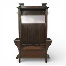 Arts and Crafts design oak settle, with projecting moulded cornice over a boarded back fit...