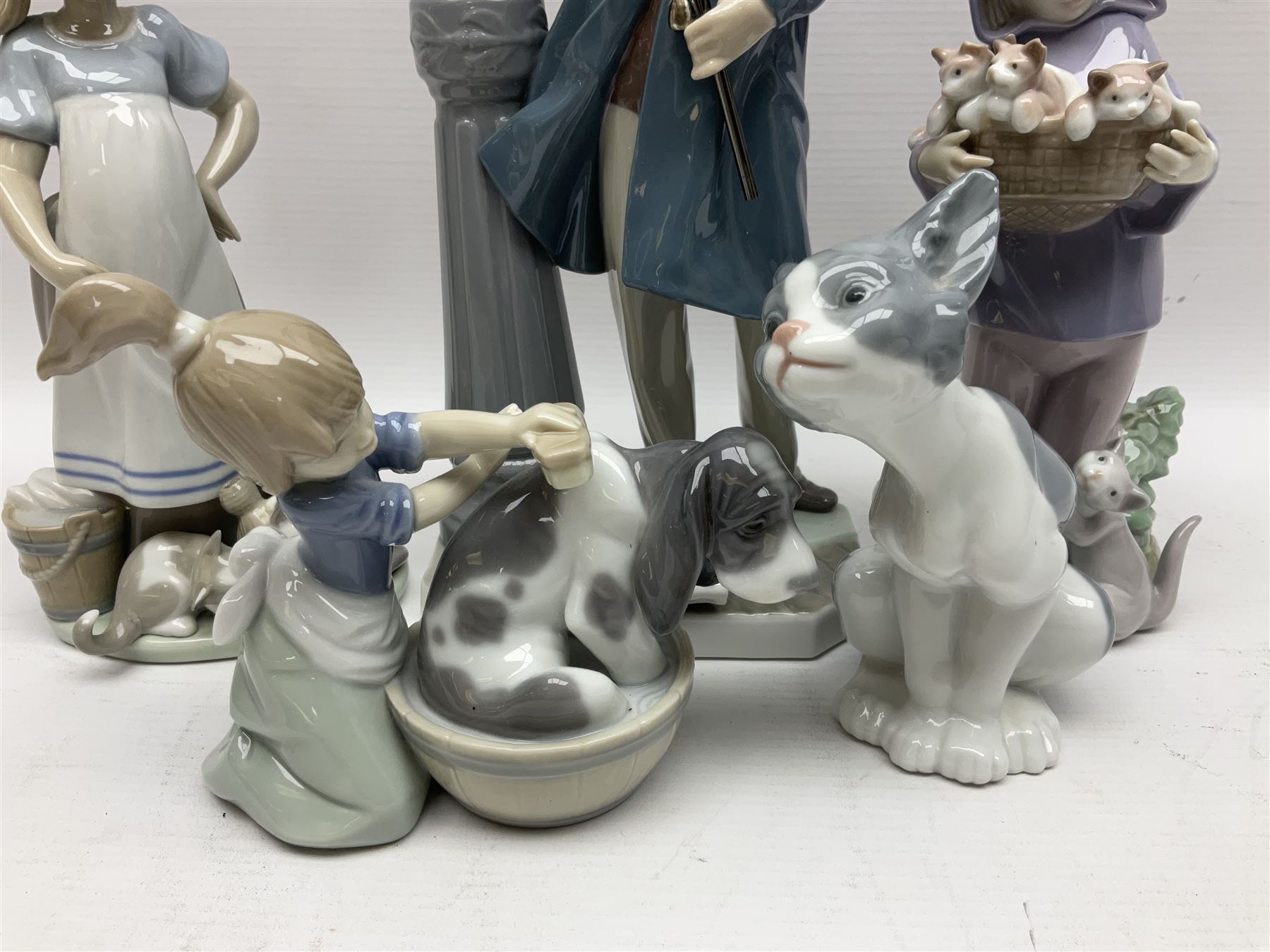 Five Lladro figures, including The Lamp Lighter no 5205,  Girl and Kittens no 6102, Cat no 5113 etc