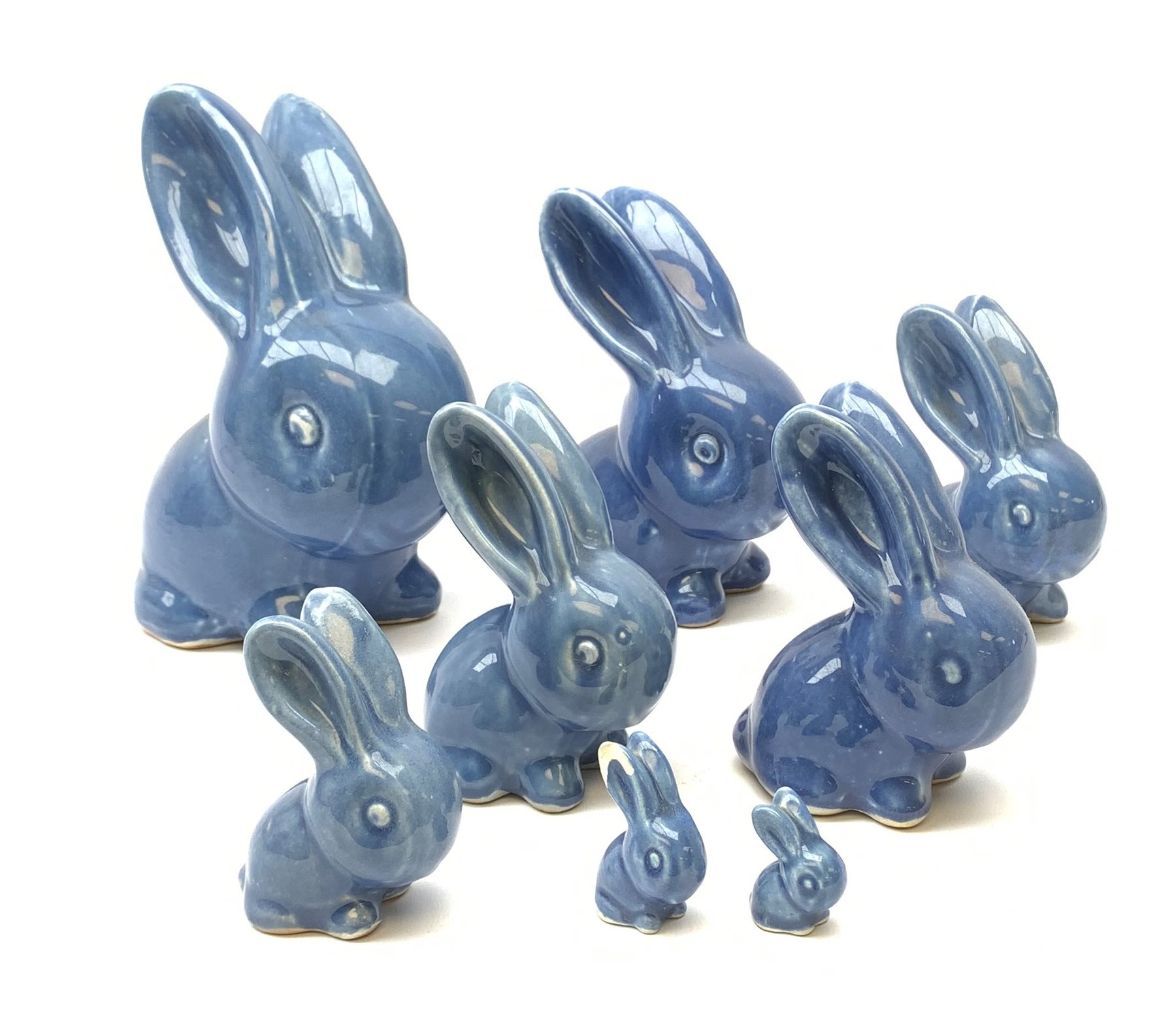 A collection of eight Denby blue glazed models of the Rabbits Marmaduke and Cotton tail, various sized, largest H20.5cm, some marked.