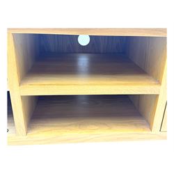 Contemporary oak television stand, rectangular top over two central open compartments, flanked by panelled cupboard doors enclosing additional shelves, raised on stile supports