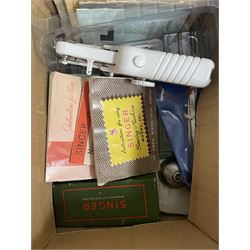 Various sewing machine accessories including Singer instruction manuals, boxed Singer pressure foots, other attachments, a child's Singer sewing machine in original box etc in two boxes