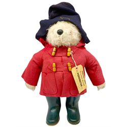 Gabrielle Designs Paddington Bear in a red felt jacket and black felt hat, c1972. Dunlop bottle green wellingtons and Darkest Peru label. H54cm