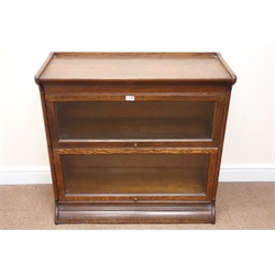  Early 20th century oak two sectional stacking library bookcase, two glazed doors, platform base, W87cm, H85cm, D37cm  