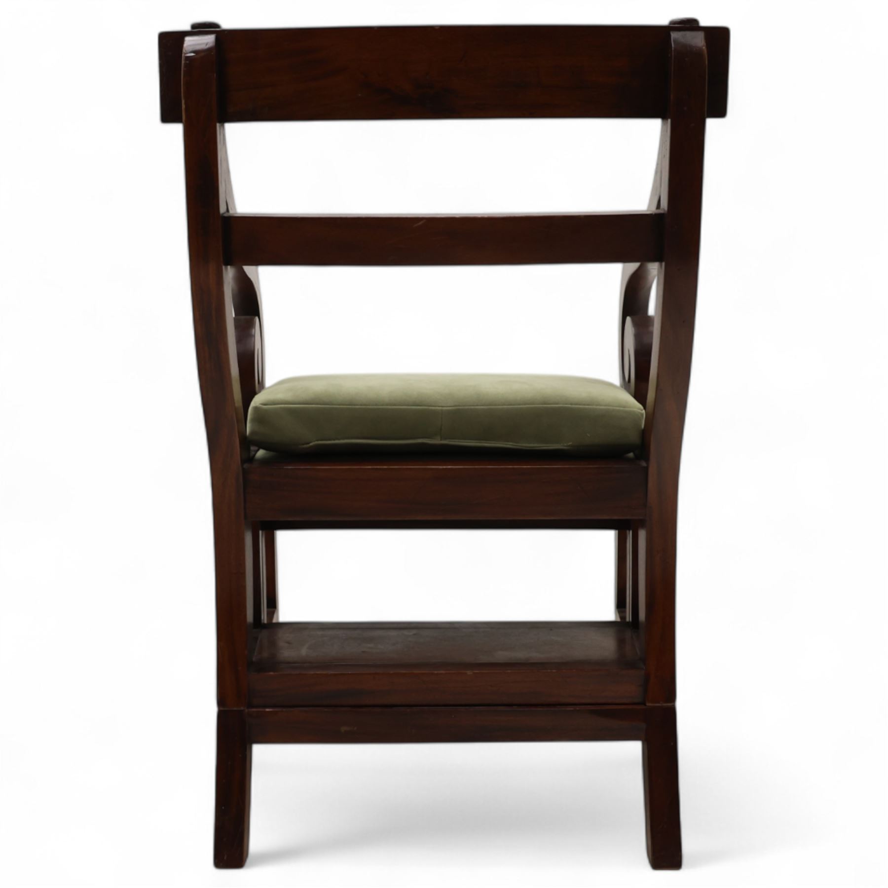 In the manner of Morgan & Sanders - early 20th century Regency design mahogany metaphoric library chair and steps, rectangular panelled top-rail with applied roundels with scrolling arms and upholstered seat and cushion, hinged and folding design transforming into four carpeted steps

Reference: The present lot is based on a design for a metamorphic library chair published by Morgan & Saunders circa 1810, P.Agius, Ackermann's Regency Furniture & Interiors, plate 29, page 60