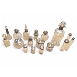 Collection of silver mounted glass bottles and jars, including decanter with etched floral decoration and silver collar, four scent bottles with silver caps, etc all hallmarked 