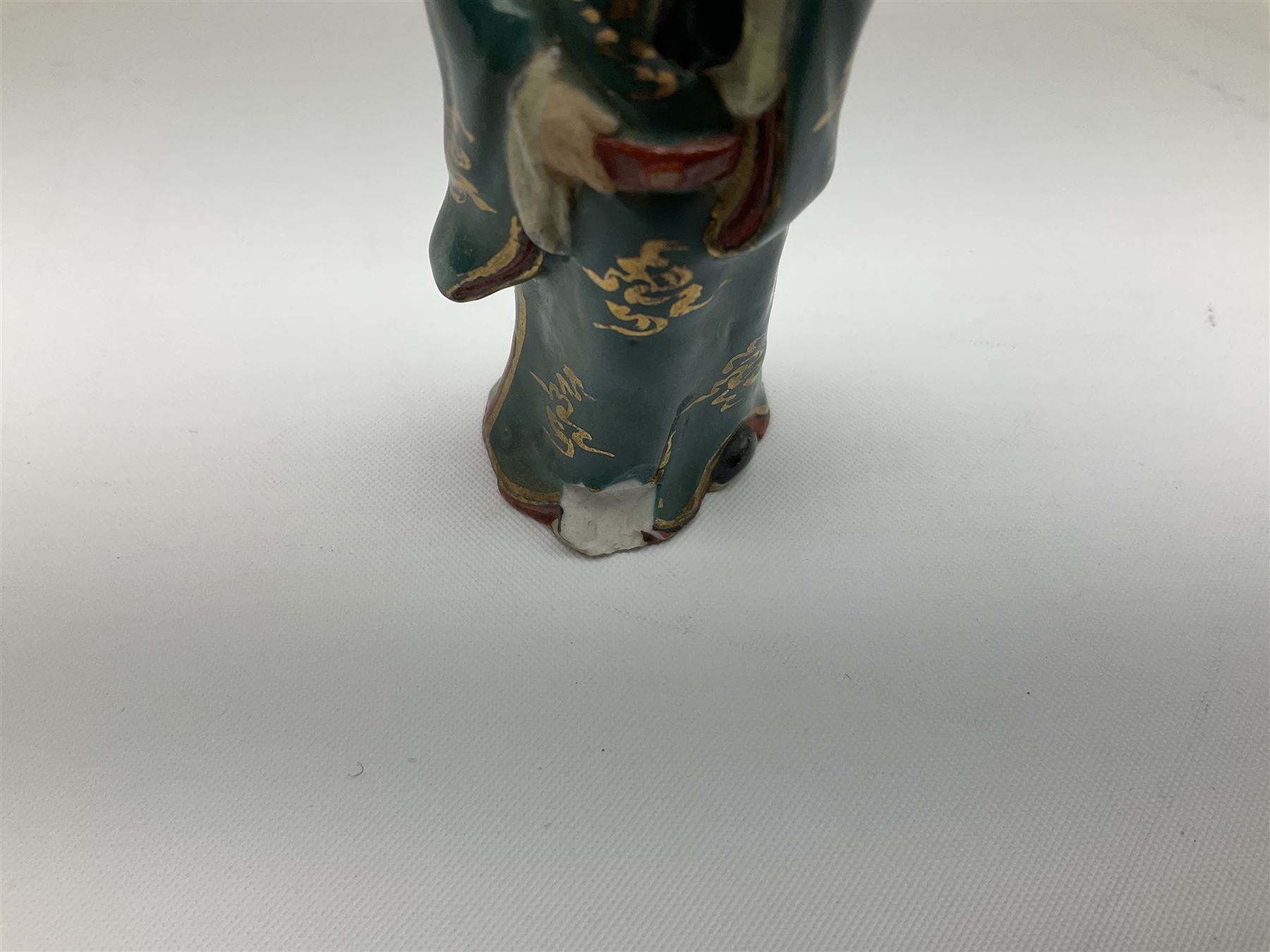 Japanese parquetry puzzle box L12cm; another Japanese puzzle box with marquetry top of Mount Fuji; eleven graduated Chinese figures including immortals; and Chinese figure of a lady standing on a hardwood base next to a horn table (14)