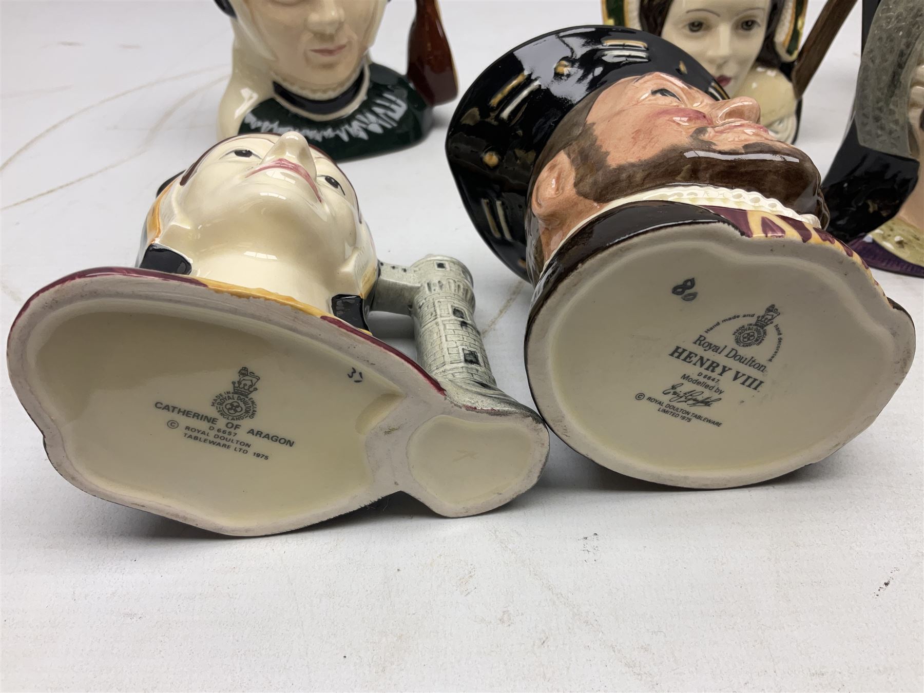 Royal Doulton Henry VIII and his Six Wives Character Jugs, comprising of Henry VIII D6647, Catherine of Aragon D6657, Anne Boleyn D6650, Jane Seymour D6746, Anne of Cleves D6753, Catherine Howard D6692 and Catherine Parr D6751, tallest H10cm