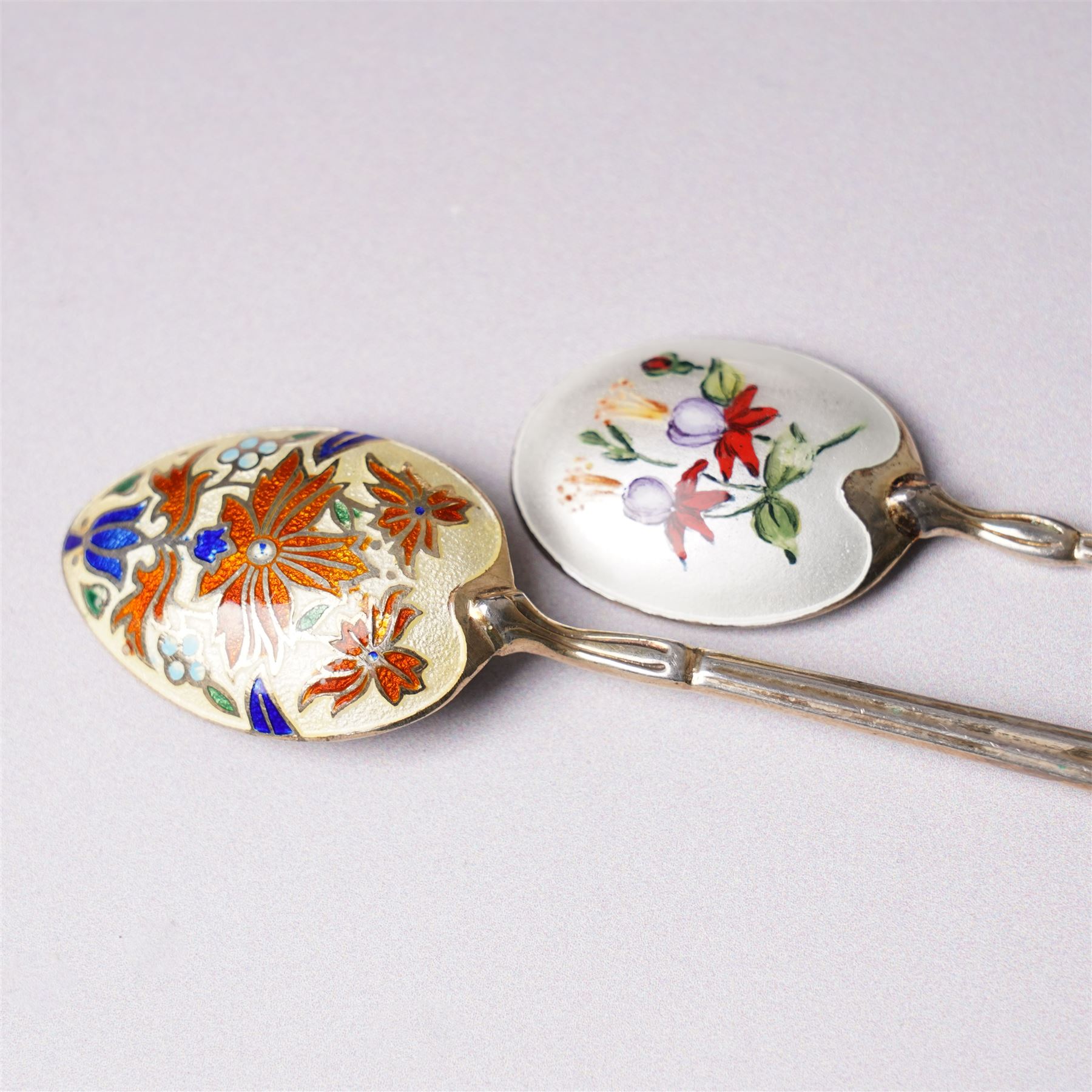 Small silver photograph frame,  four decorative silver forks, two silver and enamel spoons, other silver spoons and silver cased fob watch 