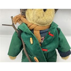 Lakeland Bears teddy bear, titled 'Walkright', dressed as a hiker in green corduroy duffle coat over fair isle jumper, trousers and knit socks, complete with leather clogs with wood soles, walkers thumb stick, knitted scarf, flat cap and rucksack housing original tag and map, H50cm