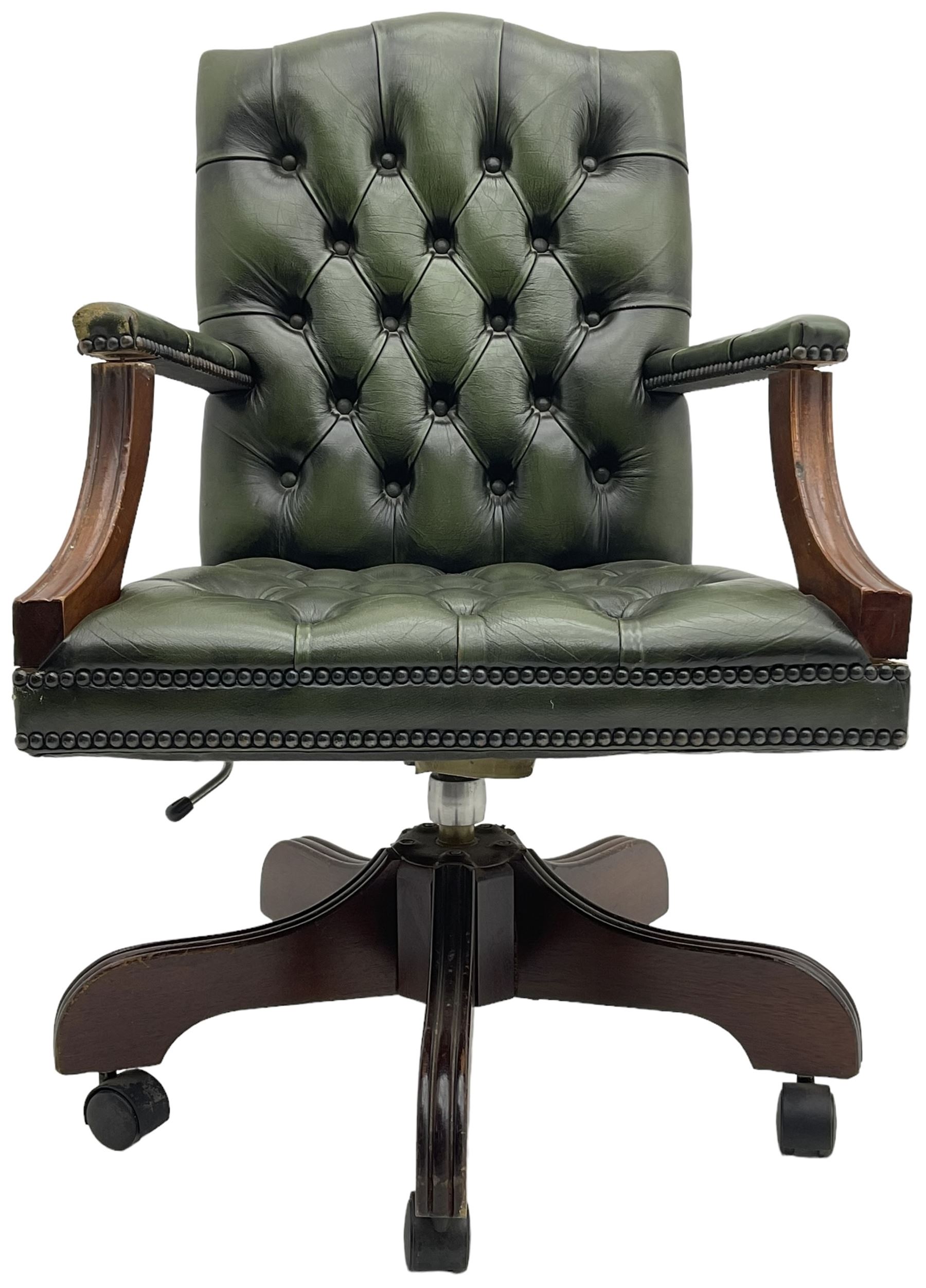 Georgian design swivel office desk chair, upholstered in buttoned green leather, on five spoke base with castors 