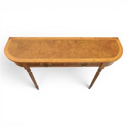 Traditional design walnut D-end hall table, figured top and sides, two frieze drawers with brass handles raised on fluted and turned supports