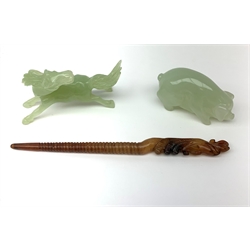 A carved jade pig, L6.5cm, together with a carved jade horse, L10cm, and a russet jade hair pin with carved zoomorphic terminal, L17cm.