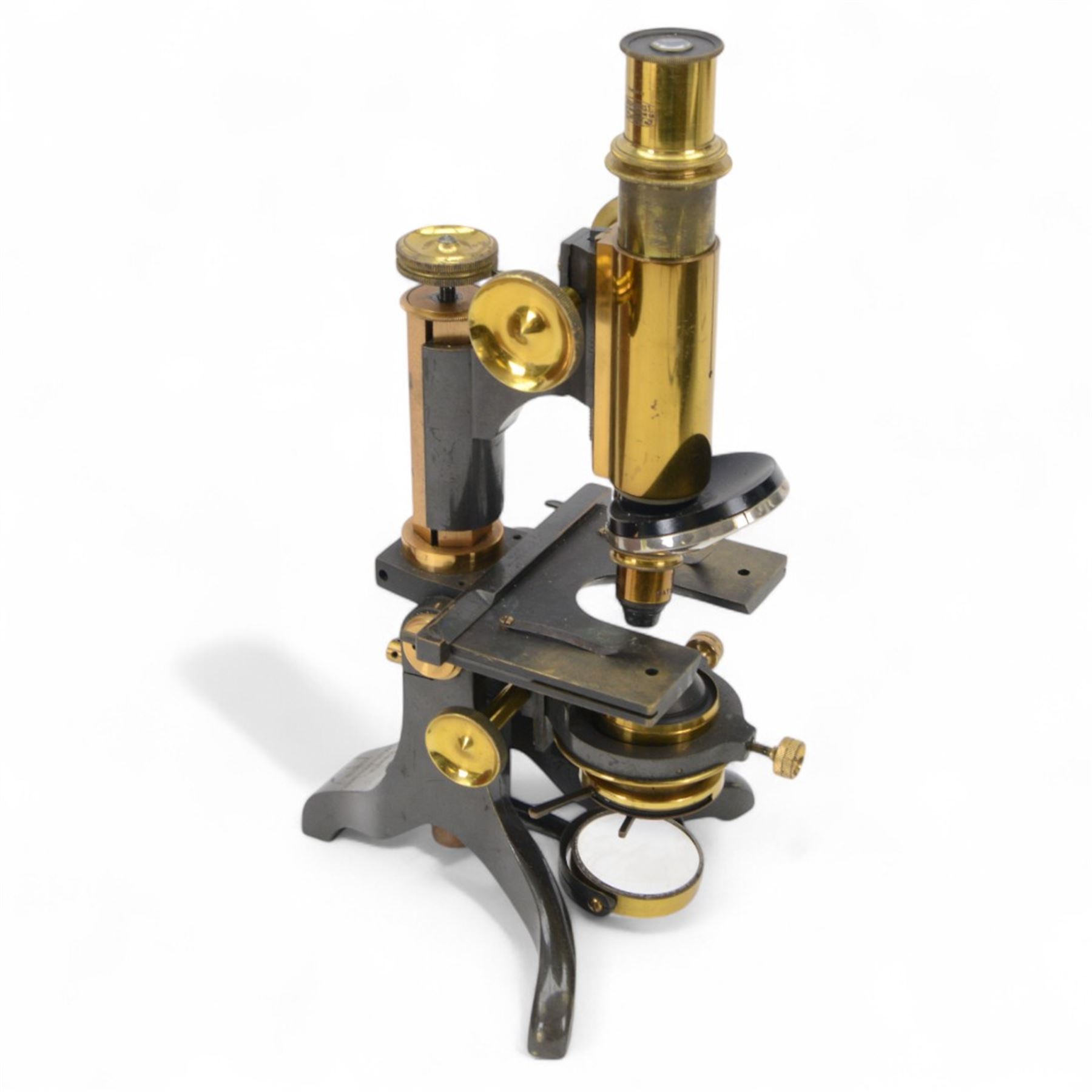 Early 20th century brass microscope, with black lacquer finish by C. E Baker of High Holborn, with lenses and plates contained within a wooden case, together with a collection of prepared microscope slides of predominantly histological and botanical specimens, contained within a wooden case