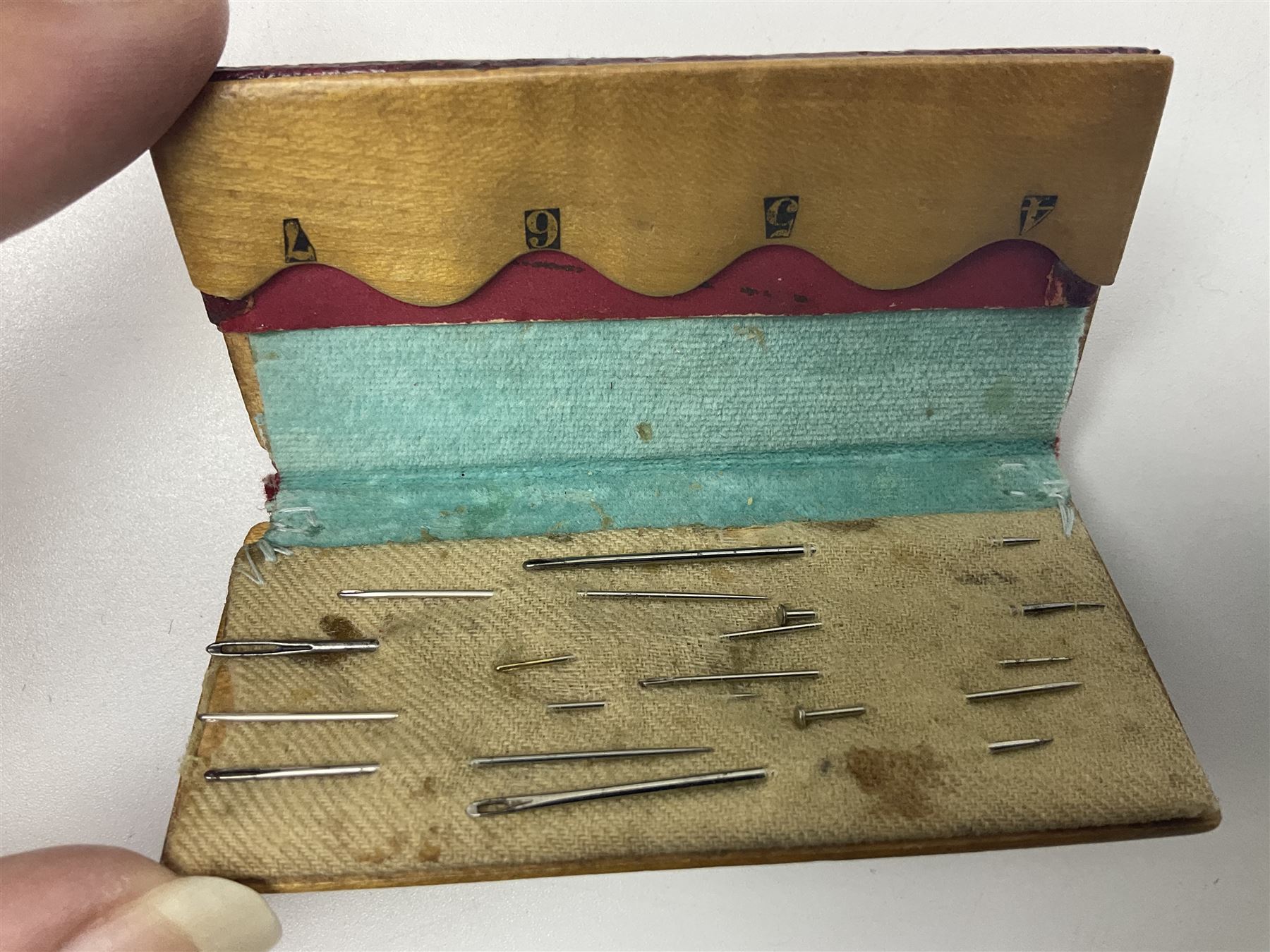 Six sewing related Mauchline ware comprising an oval reel box with internal label for Clark & Co's, tape measure, pin case and three thimble holders of ovoid form 