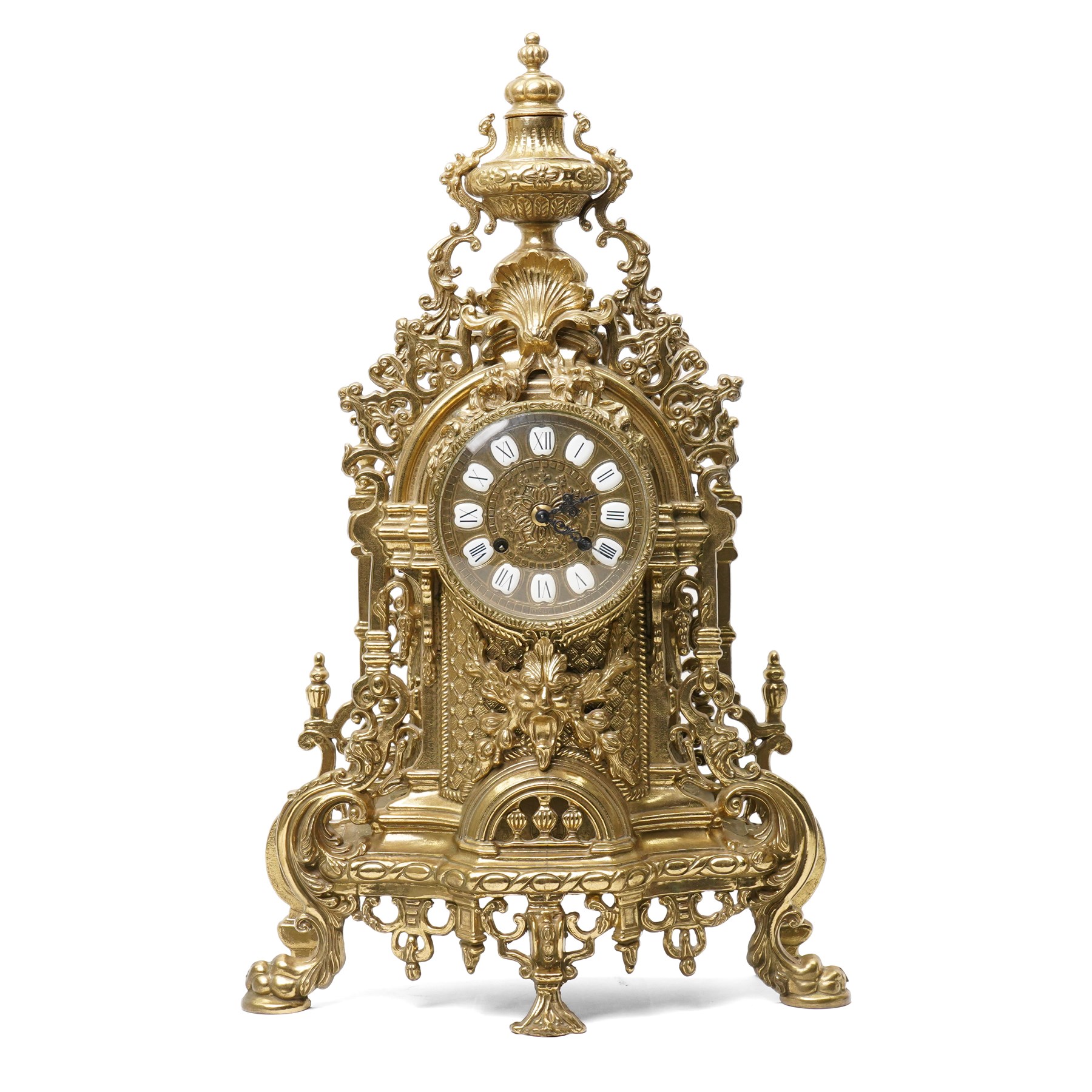 19th century design mantel clock, the brass dial with porcelain numerals, bell strike in brass case of rococo design with urn finial H60cm