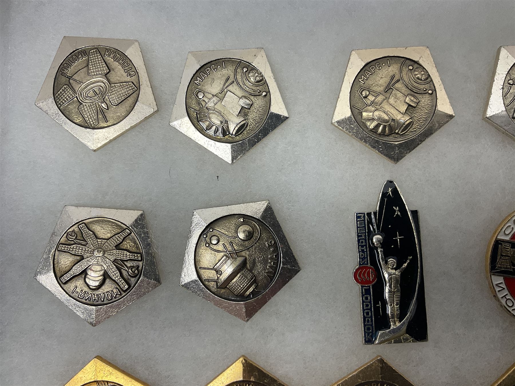 Twenty-six Russian Soviet Space badges 1960s/70s; in small display case