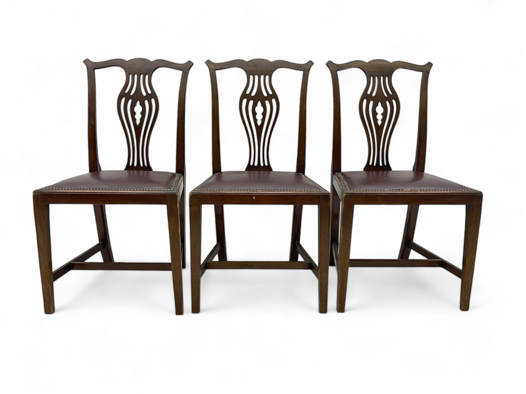 Set of six (4+2) 19th century Chippendale-design mahogany dining chairs, shaped cresting rail over pierced bulbous vase-shaped splat, burgundy leather upholstered seats with brass stud trim, on square tapering supports united by H-stretchers
