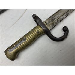 French Model 1866 Chassepot bayonet with 57cm curving fullered steel blade dated 1873 No.L63963; in steel scabbard with conforming number L71.5cm overall; and French St. Etienne Gras bayonet dated 1878 No.K10674 in steel scabbard numbered 79437 (2)