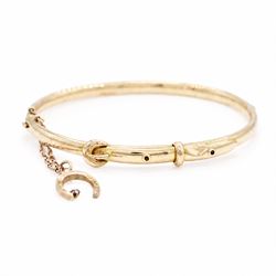Early 20th century 15ct gold buckle hinged bangle, stamped 15, the safety chain with a 9ct...