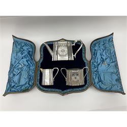 Victorian three-piece silver tea service, comprising teapot, twin handled open sucrier and milk jug, of oval form with shaped rim and C handles, each engraved with crests and bands of strapwork decoration, the milk jug and sucrier with gilt interiors, hallmarked Josiah Williams & Co, Exeter 1881, the teapot with ivory insulators and finial, all contained with a tooled leather, blue silk and velvet lined fitted case, retailed by West & Sun, Dublin 
This item has been registered for sale under Section 10 of the APHA Ivory Act