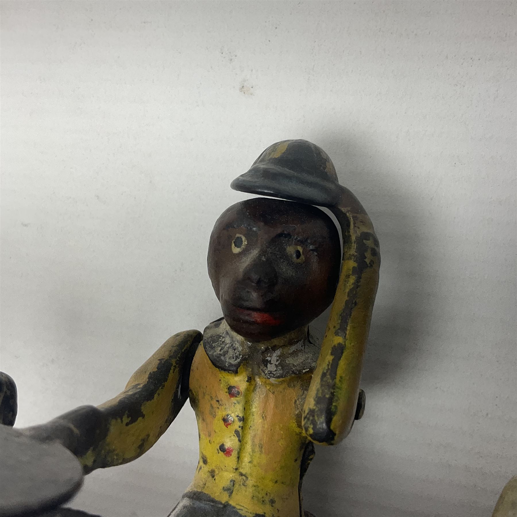 American 'Organ Bank' musical cast-iron mechanical money bank with hand cranked action and seated figure with two dancing dogs on top; locking door to base (no key); marked to the back 'Pat June 13 1882', H19cm