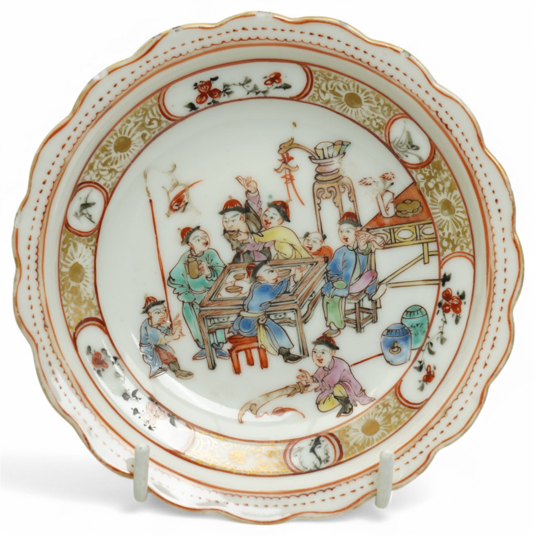 Set of Chinese 20th century tea wares, comprising three bowls of graduating sizes, teacup, spoon rest and small plate, decorated with scenes of figures around a table, each with scalloped rim, largest bowl D12cm