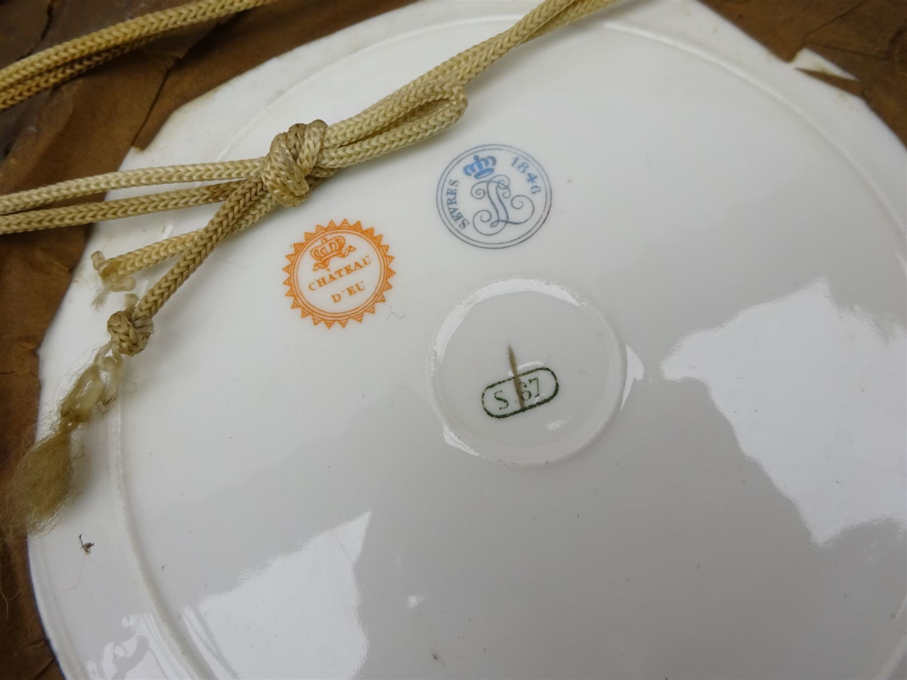 Pair mid 19th century Sevres porcelain plates, with gilt Louis Phillippe crowned monogram to centre upon a white glazed ground, with blue crowned LP mark, iron red destination mark for Chateau D'Eu, and chrome green cancelled potting mark S67 beneath, in carved oak mounts, overall D34cm
     