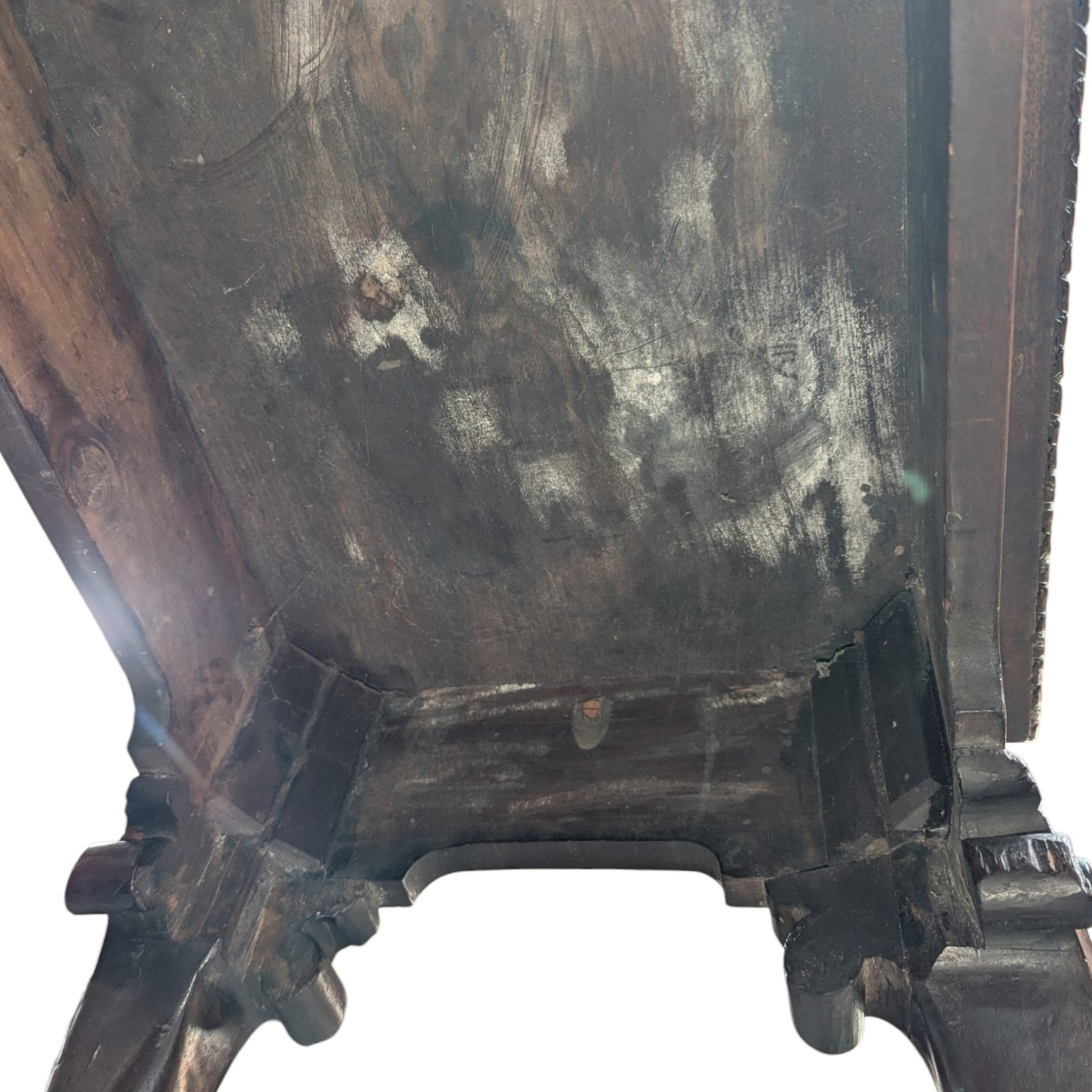 George I carved mahogany side table, adapted from a card table, the rectangular top with foliate-carved edge above a plain frieze, raised on cabriole legs with acanthus-carved knees, volute brackets and floral-carved motifs, terminating to ball-and-claw feet