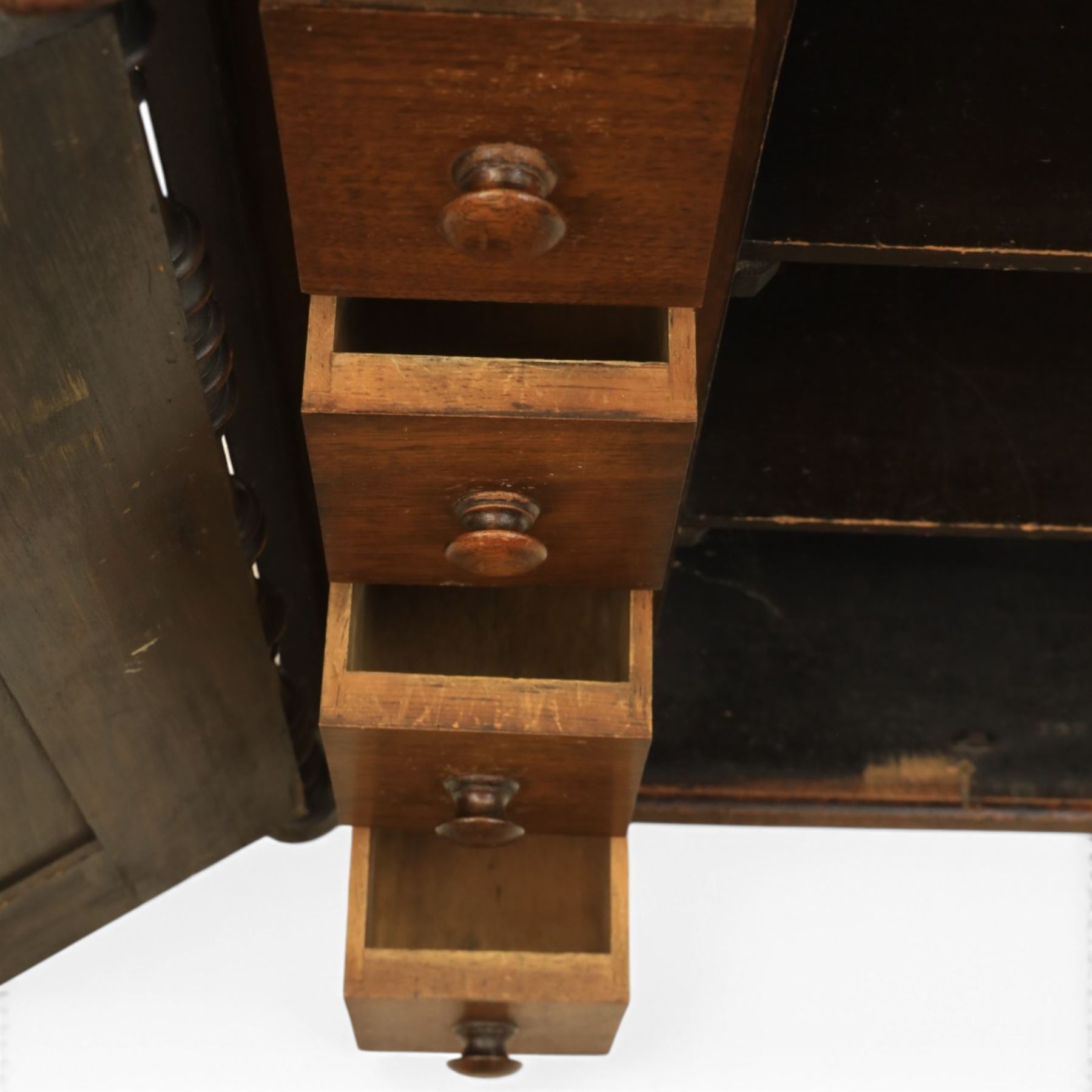 Victorian mahogany low cabinet, shaped rectangular top fitted with two arch panelled doors flanked by turned pilasters, enclosing two shelves and fitted with four short drawers with turned knobs 