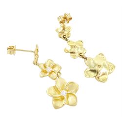 Pair of gold cubic zirconia flower head earrings, each stud with three graduating flowers, each set with a single cubic zirconia