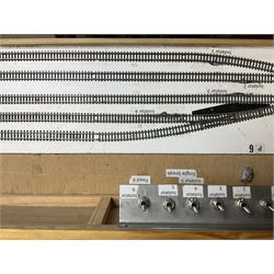 'Z' gauge continental scenic layout with folding legs, various loops of track and sidings with overhead cables, buildings including water tower, tunnels, roads with motor vehicles and figures, trees, haven with boats, backdrop diving wall hiding control units 150 x 50cm