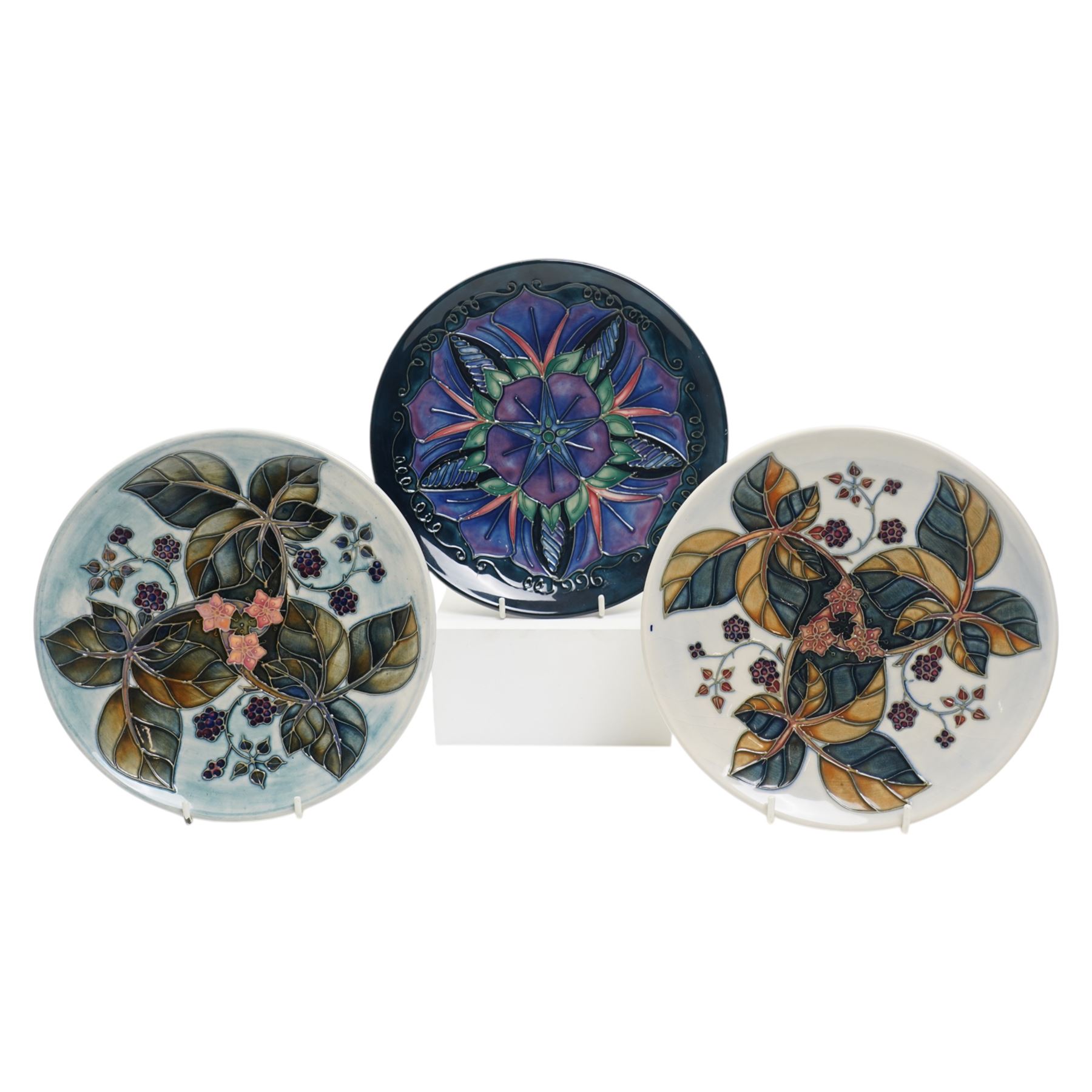 Moorcroft plates, to include the 1996 Year Plate limited edition number 106/500, with certificate, and two Brambles pattern plates, each with impressed and painted marks to base, D22cm (3)