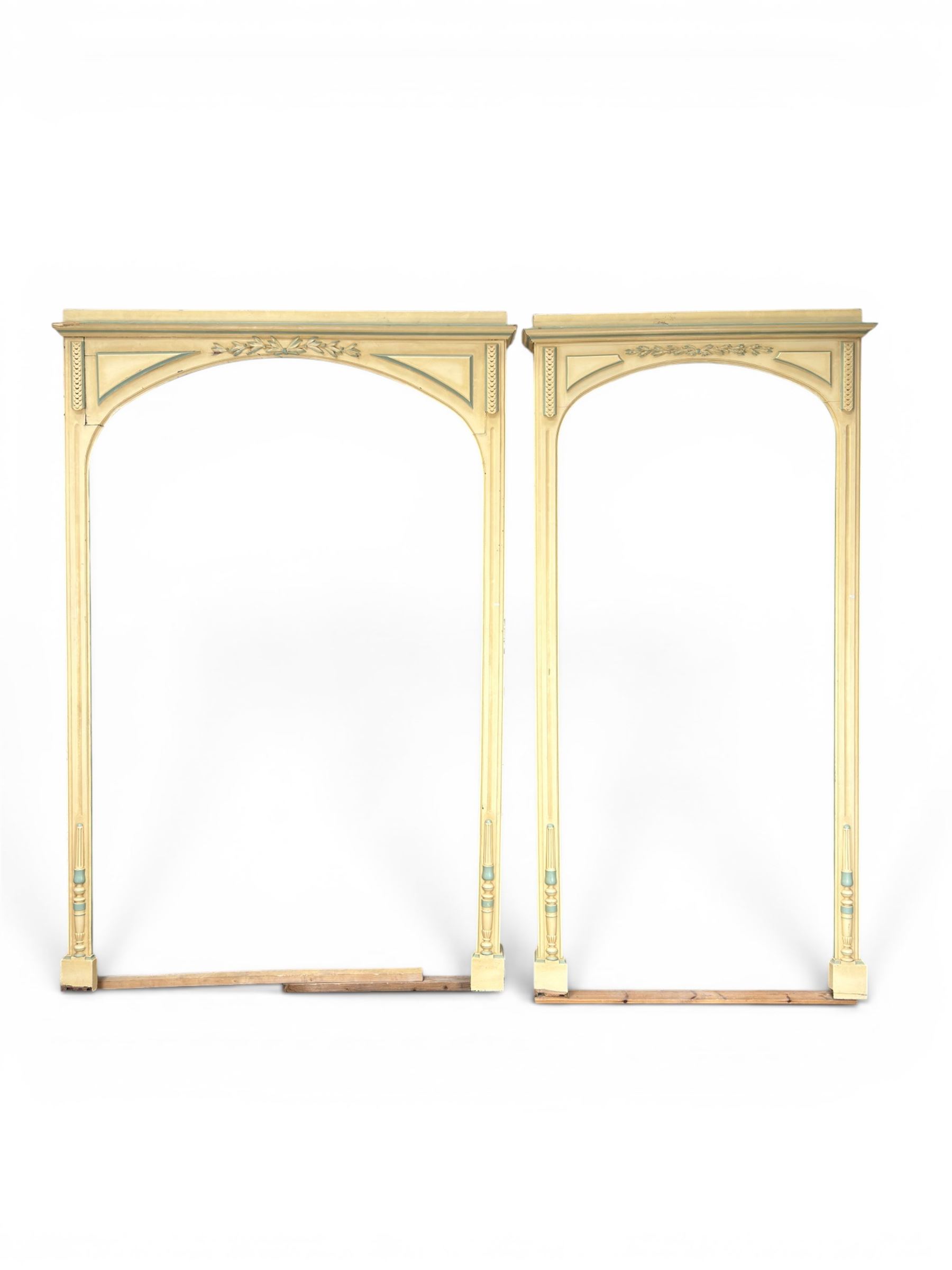 Two large painted pine window or door surrounds, square cornice with arch top, applied mouldings (widths 180cm and 130cm)
