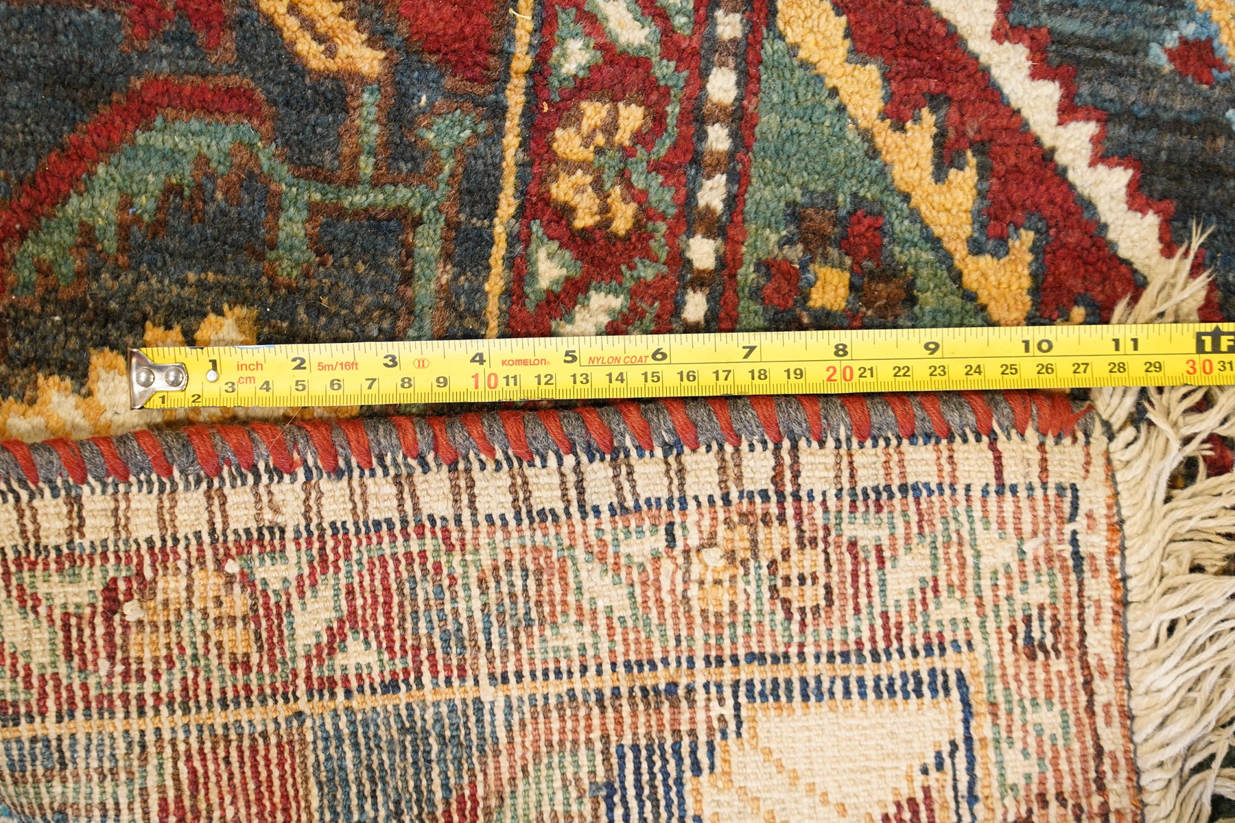 Antique Persian Qashqai dark indigo ground tribal rug, the busy field decorated with a geometric triple pole medallion surrounded by numerous stylised plant motifs with contrasting cyan spandrels, the multiple guard bands woven with stylised palmettes and foliage