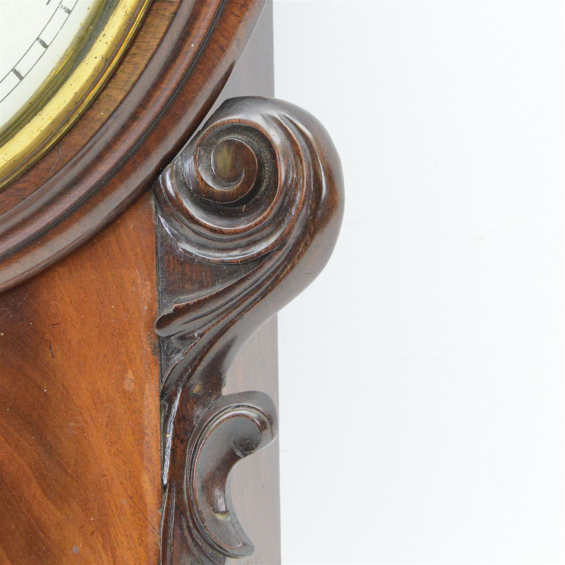 English-Late Victorian 8-day drop dial wall clock, with a mahogany case and moulded dial surround, scroll carved case ears and a curved base, pendulum regulation doors to the side and base, 12