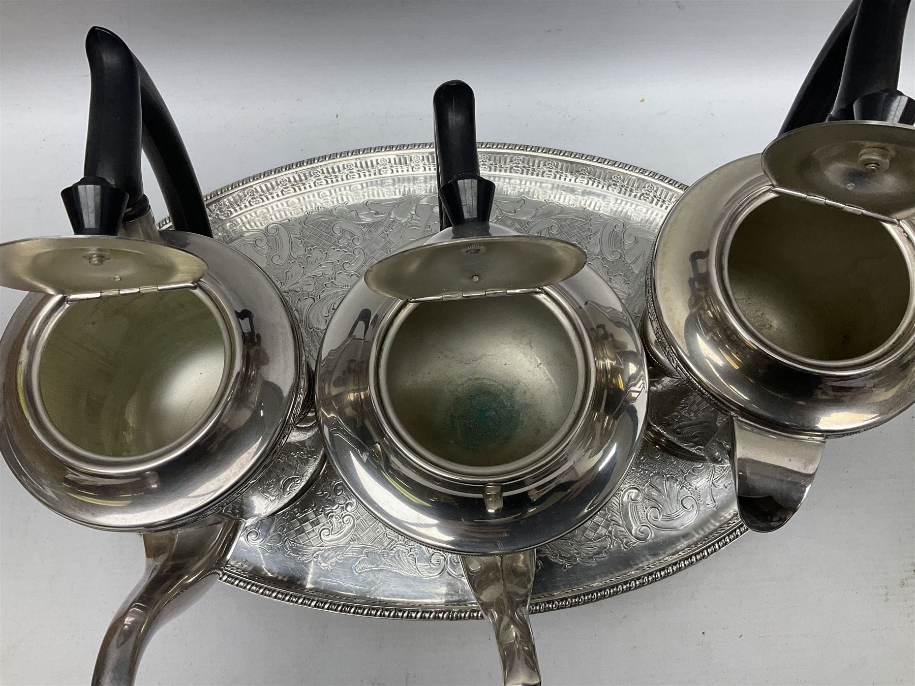 Viners of Sheffield silver-plate tea/coffee wares, the rims decorated with bands of flowers, and chased oval tray with swag decorated gallery, L39cm