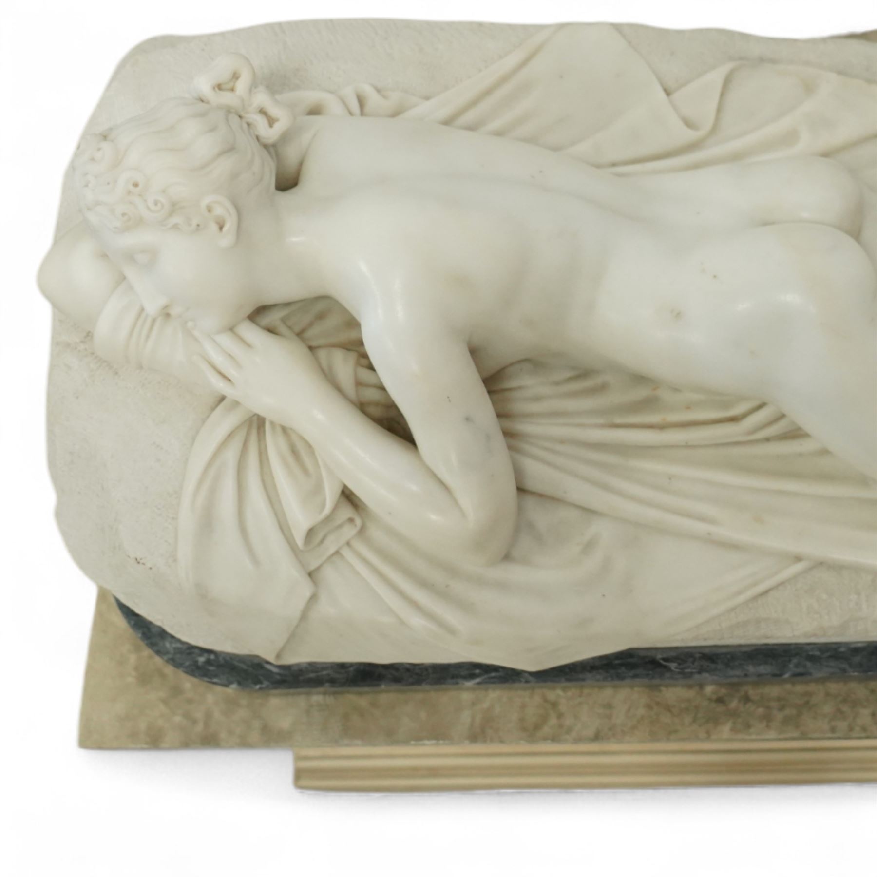 After Antonio Canova (Italian 1757-1822): 'Sleeping Venus', an Italian carved white marble figure of a reclining nude, the serene figure depicted lying on her side, her head resting on a cushion and one knee gently raised, a loosely draped sheet partially covering her lower body, on a rectangular base with rough-hewn surround, raised on a marble plinth over a sarcophagus style pedestal, circa 1900

Provenance: Kirkham Hall

Notes: A late-19th-century homage to Canova’s neoclassical models, reflecting the Grand Tour taste for idealised classical beauty and the refined finish characteristic of Italian workshop marbles of the period