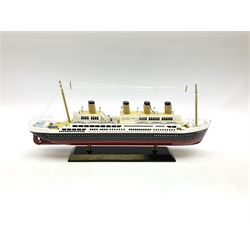 Wooden model of RMS Titanic, on a fixed black stand bearing plaque inscribed 'Titanic 1912', L54cm, H22cm, together with model of a sloop, gaff rigged on stand bearing plaque inscribed 'Sloop' L32cm, H42cm; and model of a fishing trawler on a stand bearing plaque inscribed 'Chalutier' L35cm, H28cm (3)