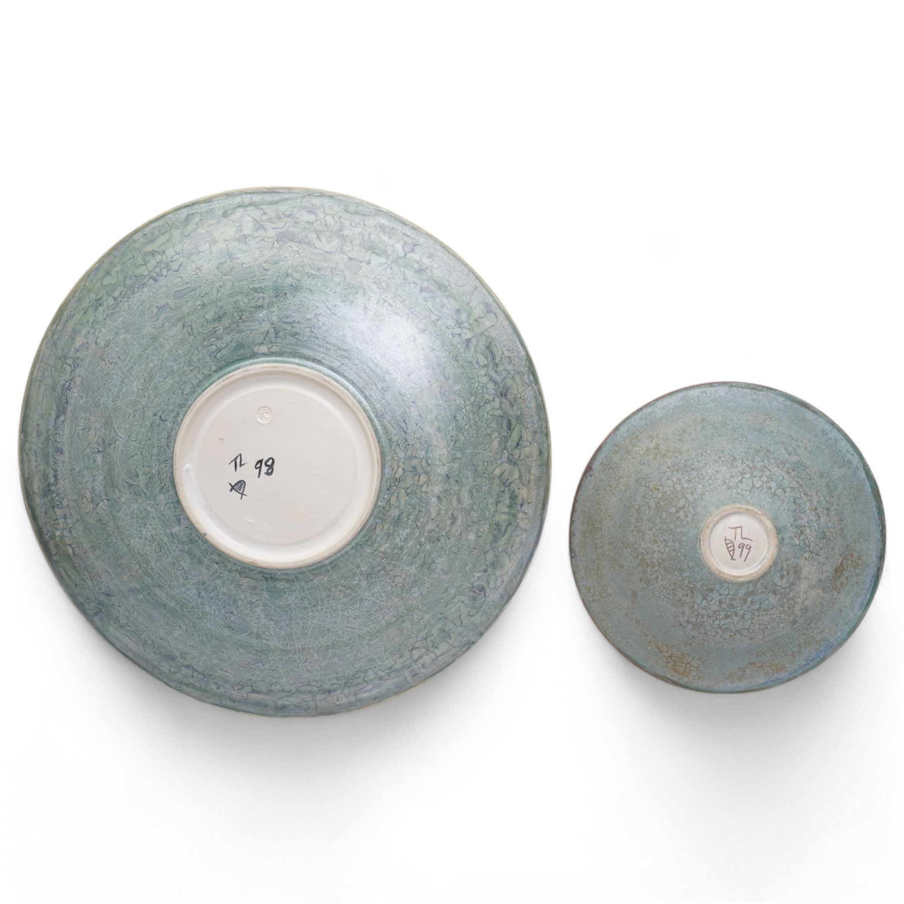 Tony Laverick (1961-); Charger painted with crossing horizontal and vertical lines of marbled blue and orange, the base signed with initials and dated '98, D42.5cm and a smaller bowl, signed with initials and dated '99, D26cm (2)
