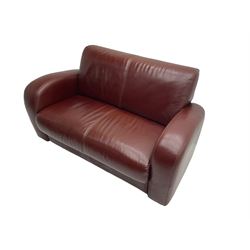 Two seat sofa, upholstered in burgundy leather