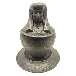 Early 20th century metal Egyptian Revival type canopic jar and cover on stand,  with an Imsety to the cover and decorated with hieroglyphics and scarabs, H20cm 