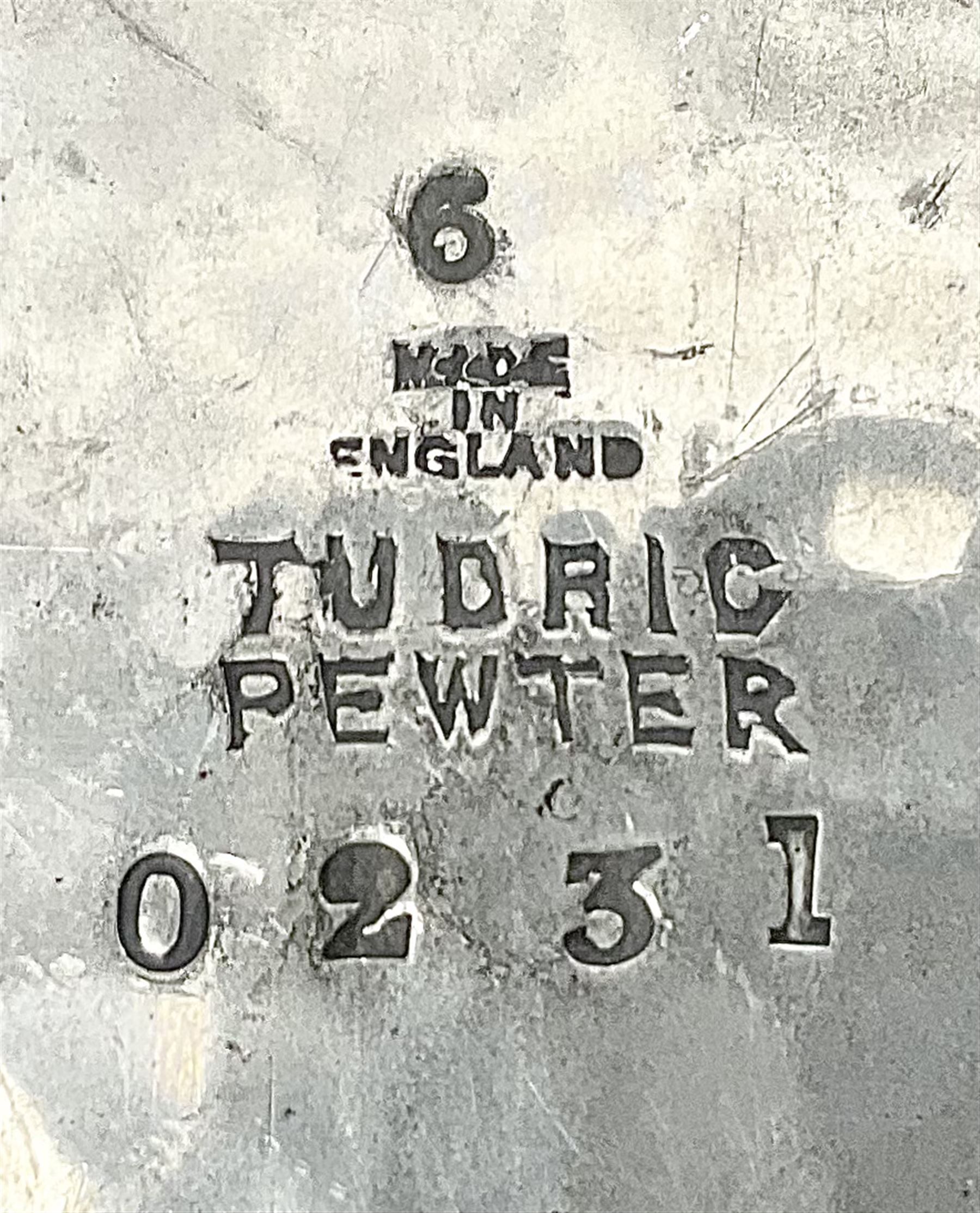 Archibald Knox for Liberty & Co Tudric pewter three piece tea service, comprising teapot with woven reed handle, single handled open sucrier, and milk jug, each with planished finish and detailed with honesty flowers, each impressed beneath Made in England Tudri Pewter 0231 