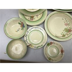 Clarice Cliff for Newport Pottery Corolla pattern tea and dinner wares, comprising triangular bowl, four side plates, two shallow bowls and teacup (a/f), together with a Clarice Cliff Wilkinson twin handled soup bowl and unassociated saucer both decorated with pink and yellow flowers, together with other mid century ceramics comprising Parrott and Company Coronet Ware, and Royal Staffordshire AJ. Wilkinson Ltd dinner wares