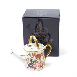 Collection of Royal Crown Derby miniature wares in Imari type patterns, comprising two champagne buckets with miniature champagne, milk churn, kettle, watering can, lawn roller, wheelbarrow, bench and kettle, five with boxes (10)