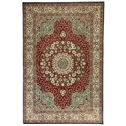 Persian design crimson ground carpet, the central rosette medallion surrounded by scrolling leaves and flower heads, the spandrels decorated with floral design and scrolling foliage, repeating border within guard stripes