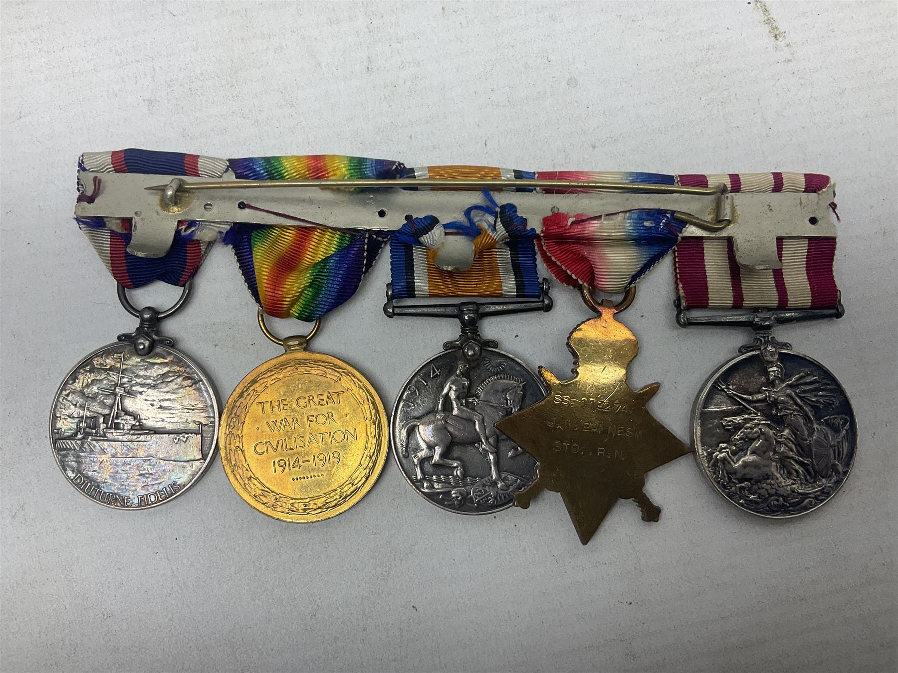 WW1 British Royal Navy Campaign and Royal Naval Fleet Reserve Long Service and Good Conduct group of five medals comprising British War Medal, 1914-15 Star and Victory Medal awarded to SS.113274 J.W. Baines Sto.1 R.N.; Naval general Service Medal to J.W. Baines Sto.1 N.B.; and Royal Fleet Reserve Long Service and Good Conduct Medal to SS.113274 (Dev. B.7397) J.W. Baines Sto.1 R.F.R.; all with ribbons