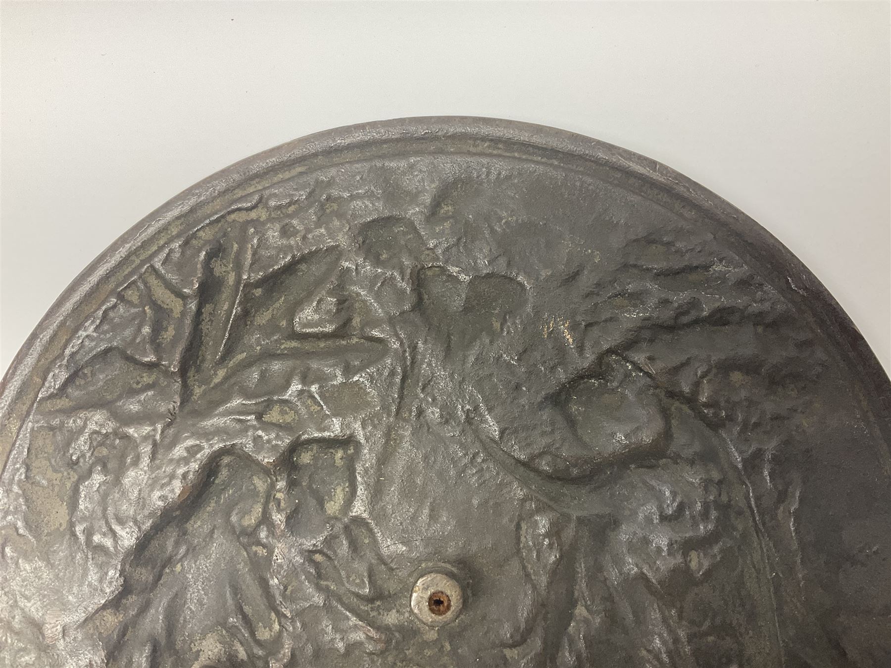 Late 19th century bronze plaque, of circular form, depicting the angel appearing to Adam and Eve in the garden of Eden in high relief, D25.5cm
