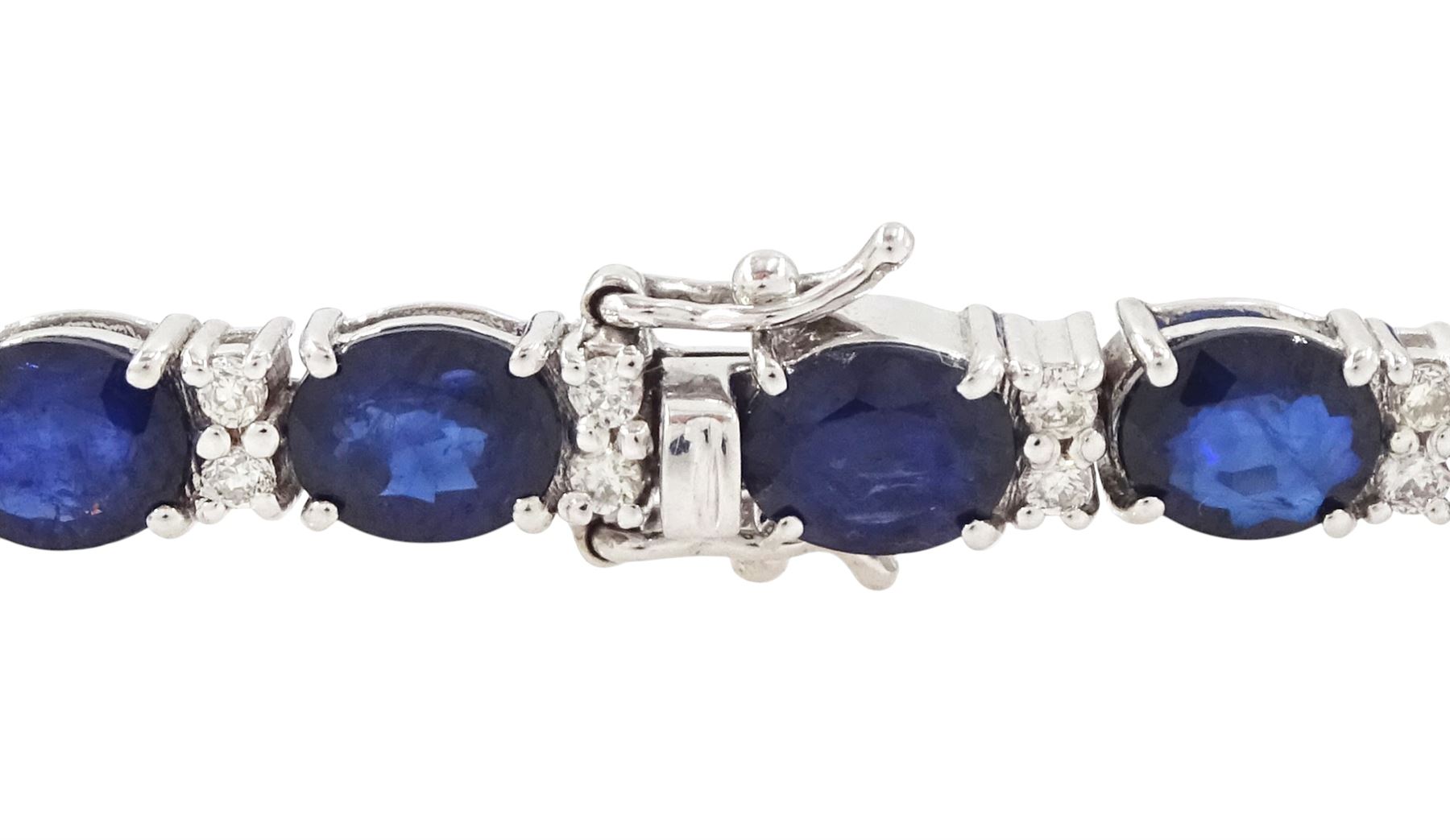 18ct white gold sapphire and diamond bracelet, twenty-six oval cut sapphires, each spaced by two round brilliant cut diamonds, stamped 750, total sapphire weight 10.60 carat, total diamond weight 0.46 carat