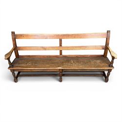 Early 20th century pine and oak bench seat, stained pine rail back frame with shaped oak arms