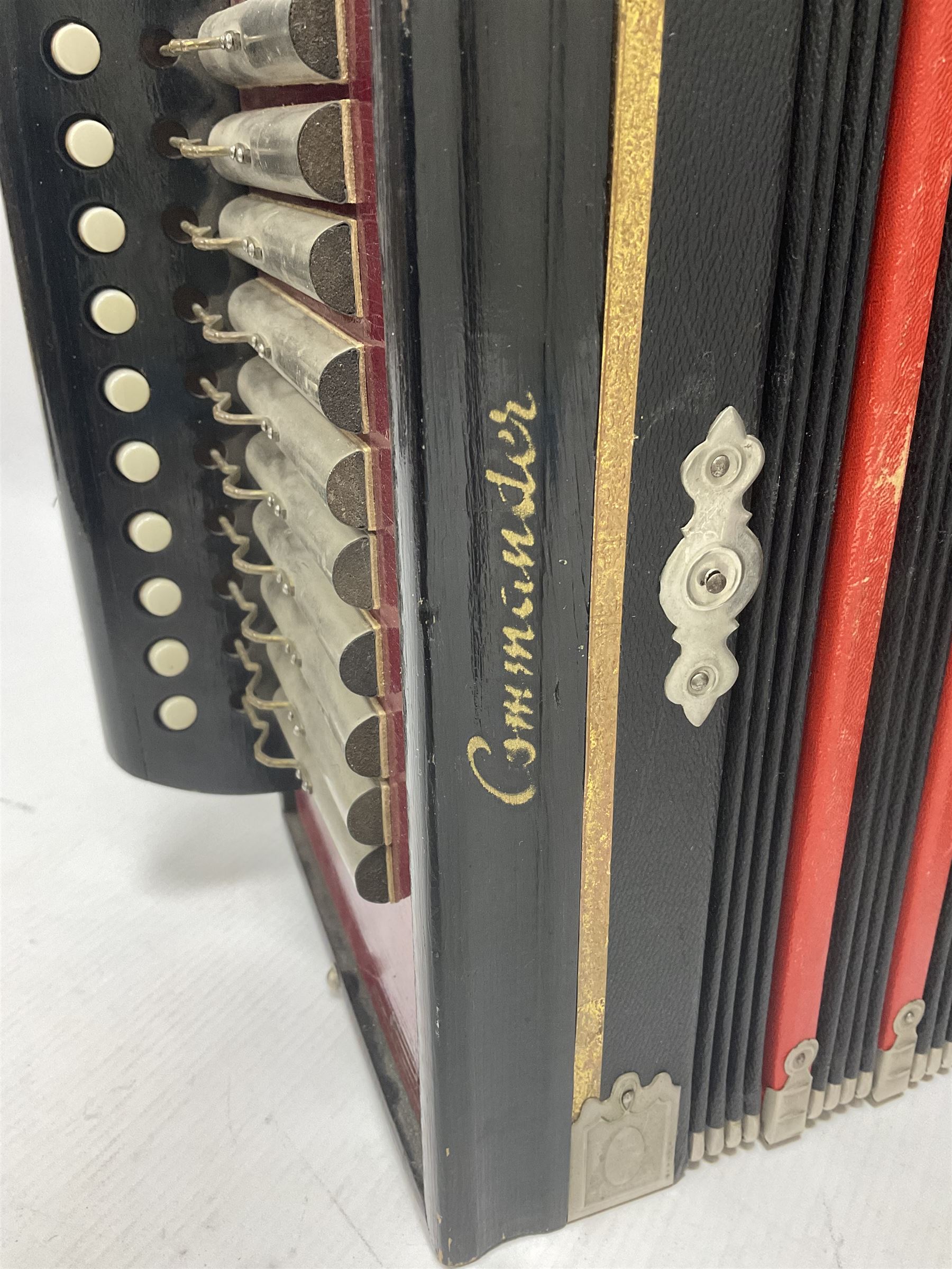 Three European concertinas, comprising Viceroy German concertina with 21 keys, hexagon wooden frame and 8 fold bellows
Oak framed concertina with 12 keys and 8 fold bellows
Commander concertina with 12 keys and 12 fold bellows
With tutor